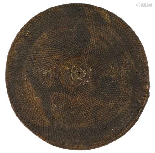 A Chinese 'tiger-face' woven shield, early 19th century, the reverse with two loop handles, 83cm