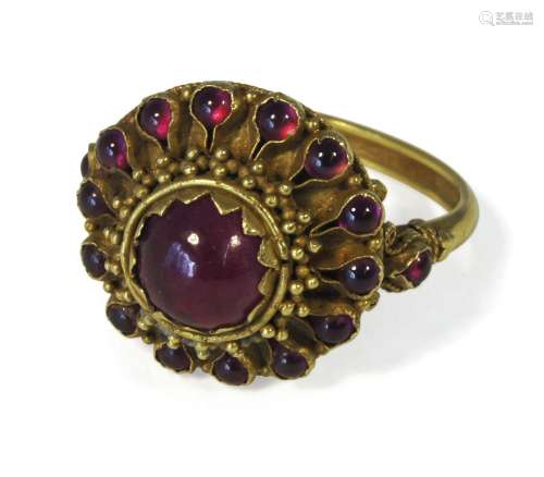 A Thai gold target ring, late 19th century, with ruby coloured paste stones in floral mountPlease