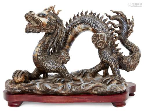 A Chinese porcelain model of a dragon, 20th century, striding forward on a base of waves, with