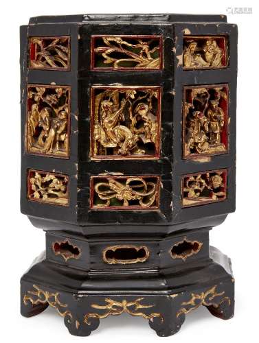 A Chinese lacquered wood octagonal box and cover, late 19th century, with gilt and carved panels