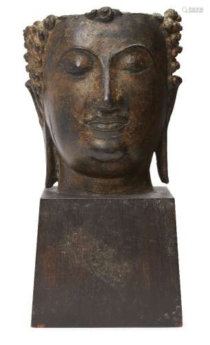 A large Thai parcel gilt bronze head of Buddha, 16th century, with serene expression and elongated
