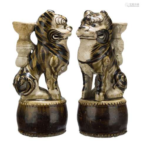 A pair of Chinese pottery Cizhou incense holders, Ming dynasty, modelled as tigers seated on a drum,