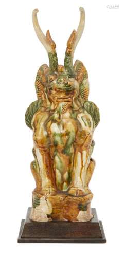 A Chinese sancai pottery figure of an Earth spirit, Tang dynasty, the seated figure with leonine