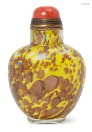 A Chinese glass ovoid snuff bottle, early 20th century, of mottled brown and yellow tones, coral