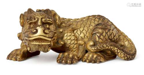A Chinese gilt bronze lion scroll weight, late 19th/early 20th century, cast in the form of a