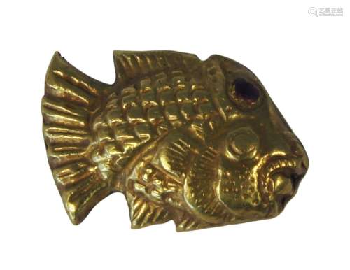 A Thai gold pendant, 17th/18th century, modelled as a fish with ruby paste set eyes, 2.5cm x 1.