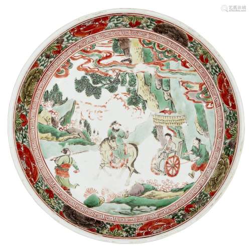 A Chinese porcelain wucai dish, 17th century, painted to the central reserve with figures travelling