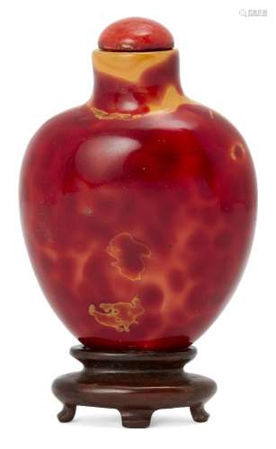 A Chinese simulated realgar snuff bottle, 18th century, of flattened ovoid form, 6cm high, coral