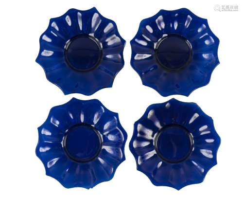 Four Chinese Peking blue glass 'lotus' dishes, late 19th century, each moulded as a lotus flower,