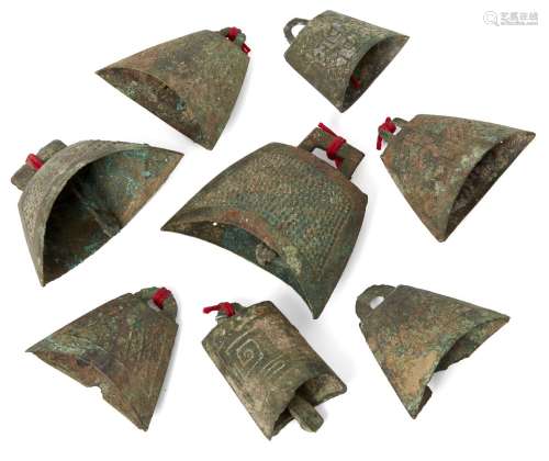 Eight miniature bronze bells, Han dynasty style, each of typical tapering form, two incised with