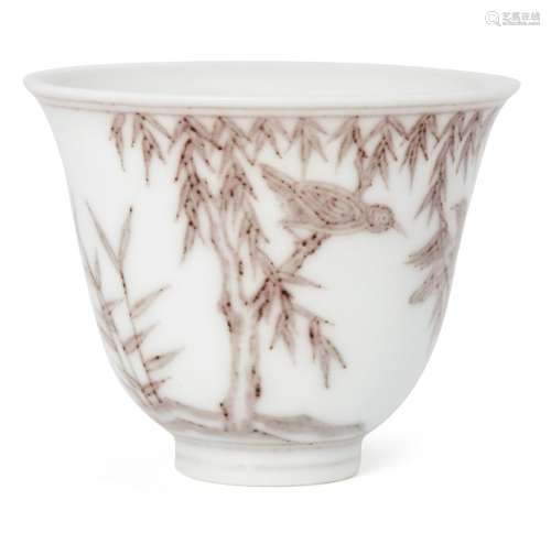 A Chinese porcelain tea bowl, 20th century, painted in underglaze copper red with birds amid