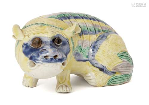 A Chinese porcelain polychrome figure of a lion, c.1800, modelled in recumbent pose, 14cm longPlease