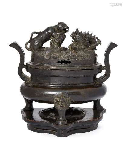 A large Chinese bronze oval tripod censer, Ming dynasty, the cover elaborately cast with a tiger