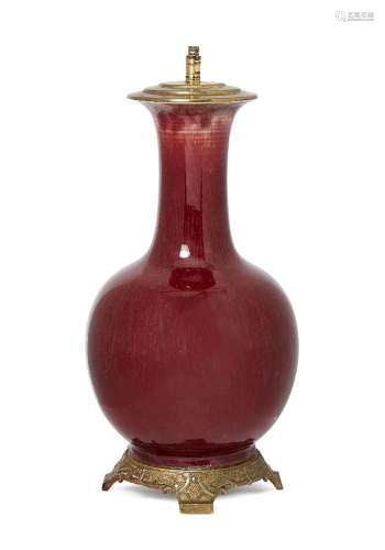 A Chinese porcelain sang-de-boeuf bottle vase, 19th century, with flared rim and bulbous body,