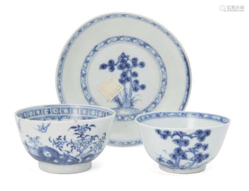 A Chinese porcelain tea bowl and saucer, 18th century, painted in underglaze blue with pine trees,