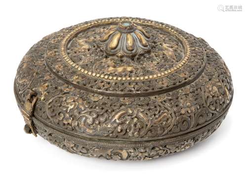 A Tibetan parcel gilt repousse circular box, 19th century, the cover with central lotus petal knop