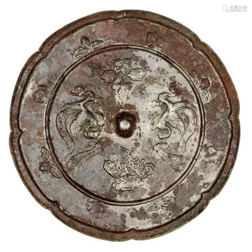 A Chinese bronze lobed mirror, Tang dynasty, the central knob surrounded by the phoenixes and two