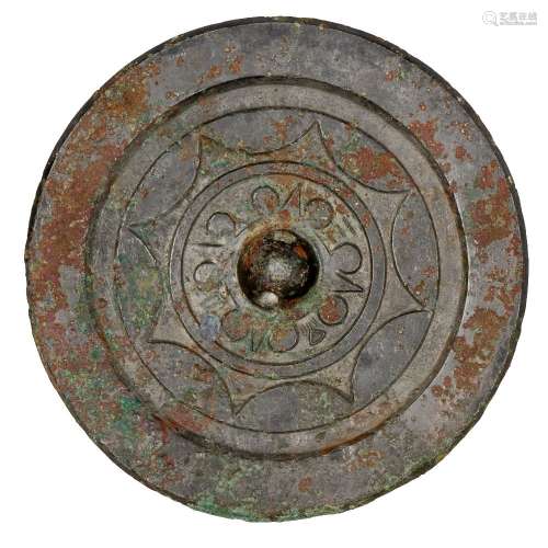 A Chinese bronze circular mirror, Han dynasty, the central raised knob surrounded by four characters