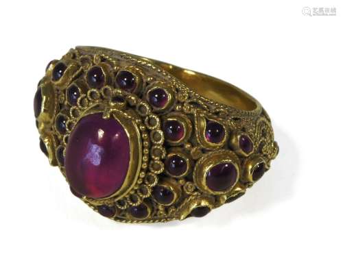 A Thai gold ring, 19th century, set with ruby coloured cabochons in filigree decorated mountPlease