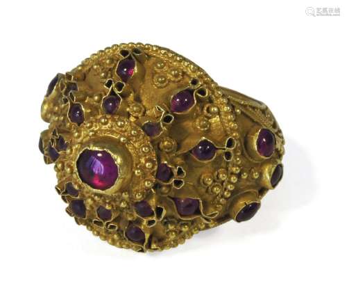 A Thai gold filigree decorated ring, 19th century, set with ruby coloured paste gemsPlease refer