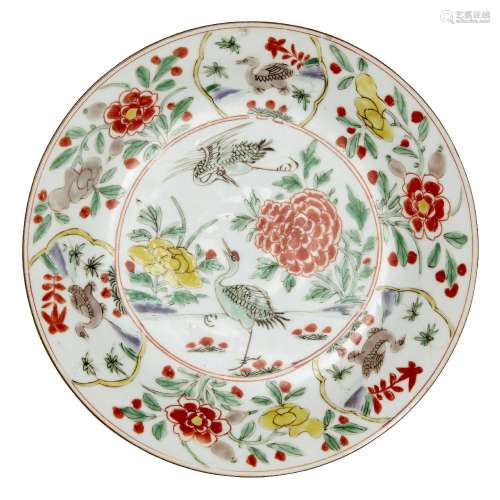 A Chinese porcelain shallow dish, Kangxi period, painted in famille verte enamels to the central