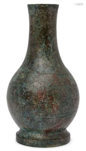 A Chinese bronze vase, hu, Han dynasty, fine incised to the neck with vertical lappets of archaistic