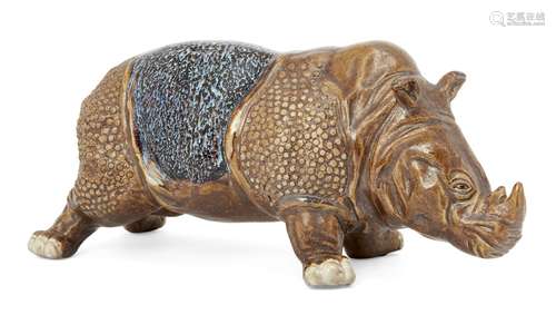 A Japanese studio pottery model of a rhinoceros, early 20th century, standing four square, glazed in