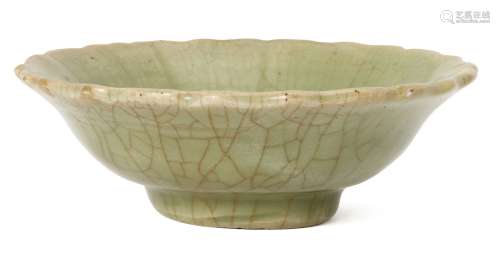 A Chinese Longquan celadon bowl, Ming dynasty, with shaped rim and impressed floral motif to central