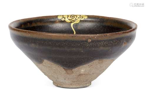 A Chinese grey stoneware black-glazed teabowl, Song dynasty, with light brown tones to glaze