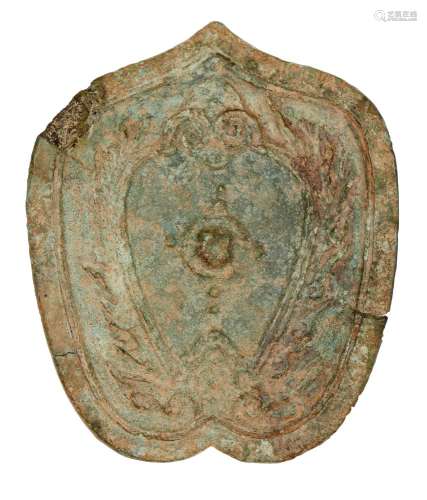A Chinese bronze leaf-shaped 'owl' mirror, Shang dynasty, decorated with a stylised owl