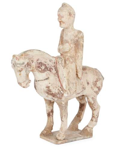 A Chinese pottery painted figure of a horse and rider, Sui dynasty, the horse standing four