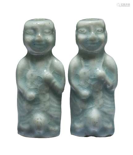 Two Chinese porcelain qingbai glazed snuff bottles, Republic period, modelled as boys holding a