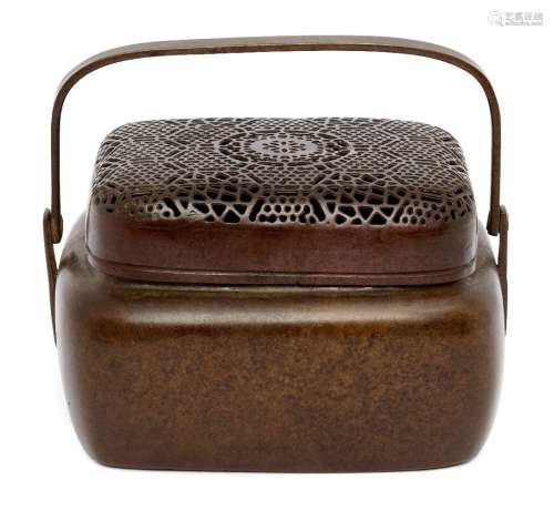 A Chinese bronze hand warmer, 19th century, of rectangular form with pierced cover decorated with