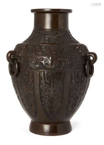 A large Chinese archaistic bronze vase, early 19th century, with three tao-tie mask and loose ring