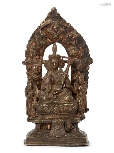A Nepalese brass figure of Padmasambhava with his consorts, 18th-19th century, seated in vajrasana