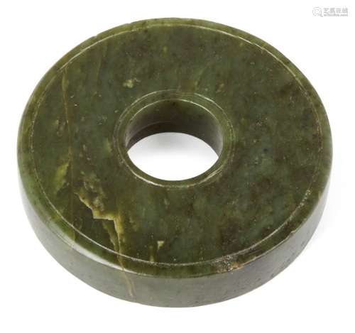 A Chinese spinach jade ceremonial bi disc, Ming dynasty, 16th/17th century, each side carved with