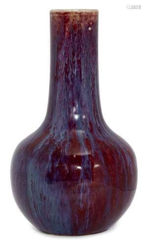 A Chinese porcelain flambé glazed bottle vase, 19th century, with rich, cherry glaze suffused with