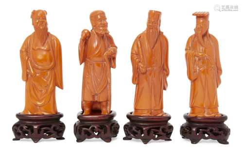 Four Chinese carved figures of Daoist immortals, early 20th century, each standing, on fitted