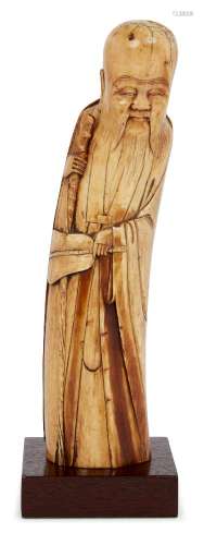 A Chinese ivory figure of Shoulao, Ming dynasty, modelled standing, holding a staff in his right