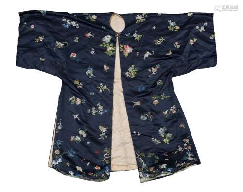 A Chinese silk blue ground robe, early 20th century, embroidered with butterflies amid floral