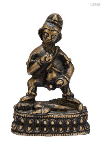 A Tibetan copper alloy figure of Kalajambhala, 12th century, modelled standing on a prone figure,
