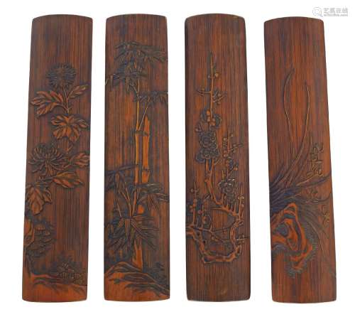 A set of four Chinese liu qing bamboo 'four seasons' wrist rests, late Qing dynasty, each carved