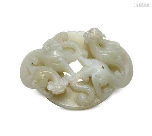 A Chinese white jade archaistic buckle, 18th century, finely carved as to chi-long dragons atop a bi