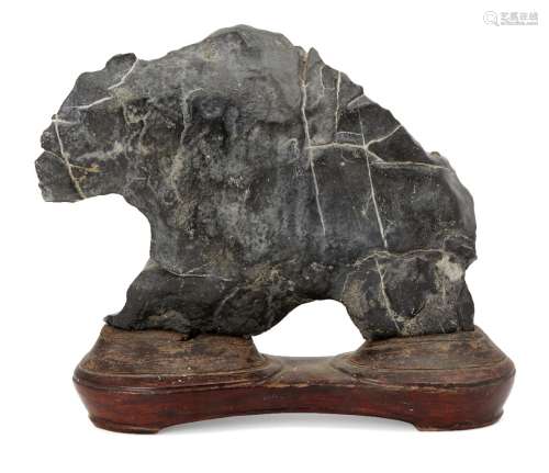 A Chinese Lingbi scholar's rock, 19th century, the dark smooth stone suffused with white veins, on