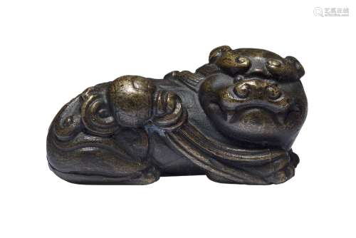 A Chinese bronze scroll weight, Ming dynasty, 17th century, modelled as a recumbent Buddhist lion,