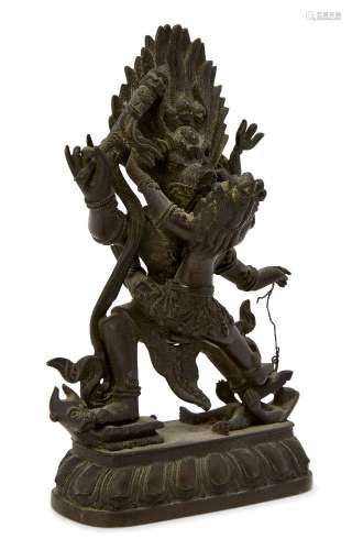 A Tibetan bronze figure of Yamantaka and consort, early 20th century, wearing a crown, with