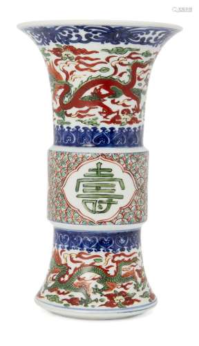 A Chinese wucai porcelain gu vase, late Qing dynasty, painted to the neck and base with dragons amid
