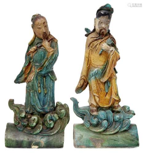 A pair of Chinese pottery figural roof tiles, Ming dynasty, each depicting a Daoist immortal, glazed