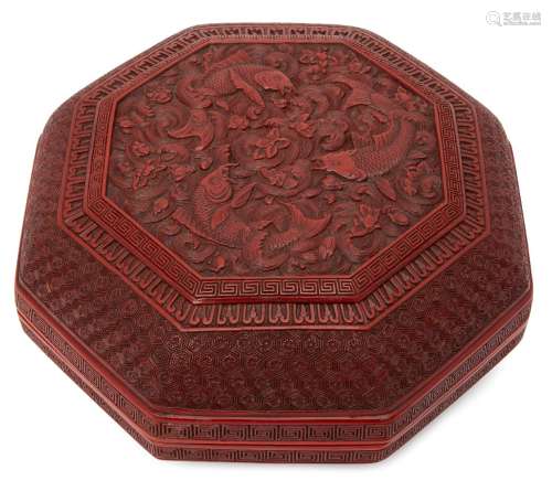 A large Chinese cinnabar lacquer octagonal box, 18th century, finely carved to the cover with