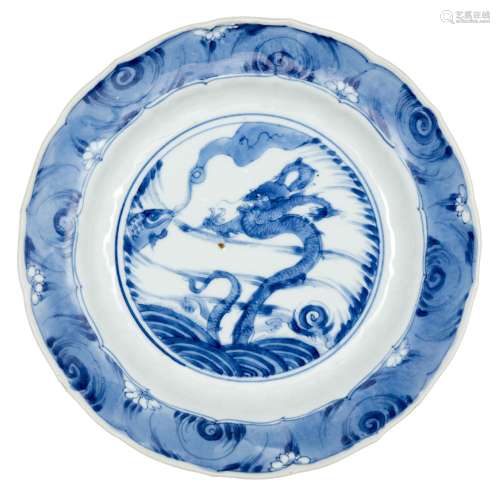 A Chinese porcelain 'dragon and carp' saucer dish, Kangxi period, painted to the central reserve